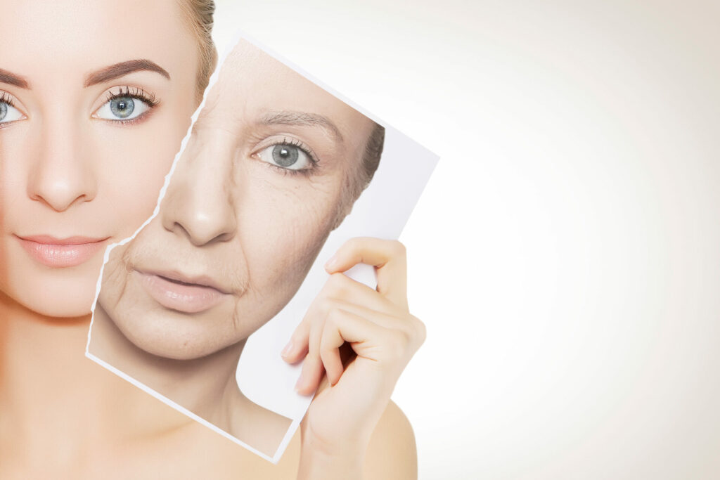 closeup portrait of young woman face holding portrait with old wrinkled face