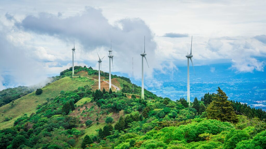 Wind farm on top of mountain showing renewable energy which is a good green investment 