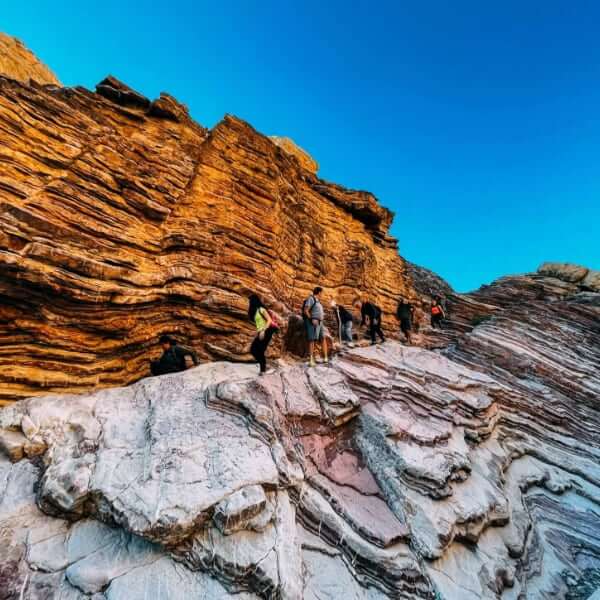 people hiking with clear blue sky 