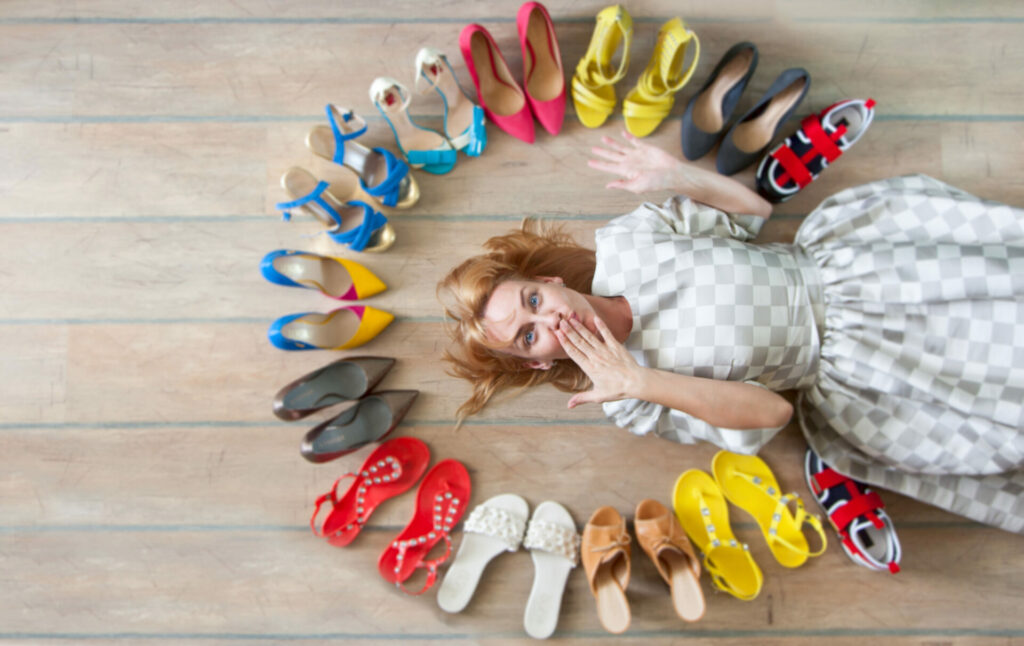 woman surrounded by shoes 