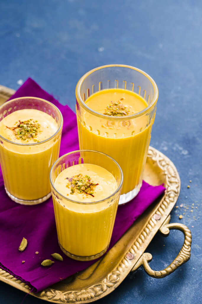 mango lassi welcome drink with saffron and crushed pistachio 