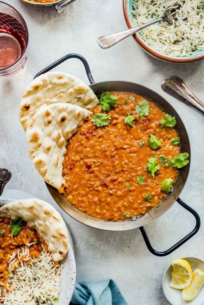 vegan red lentil dal served with cumin bric and naan bread 