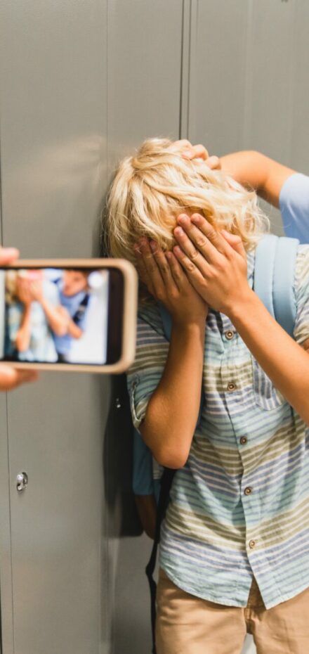 child filming a bully with his victim