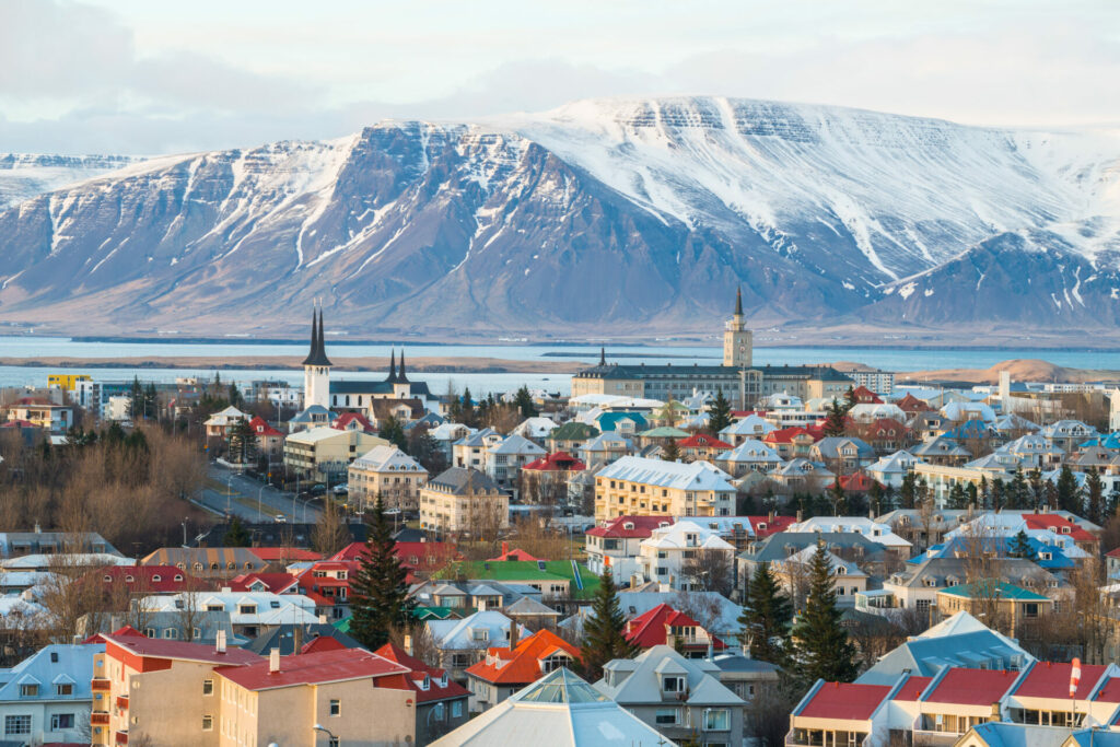 view of Icelandic capital with snow capped mountains in the distance