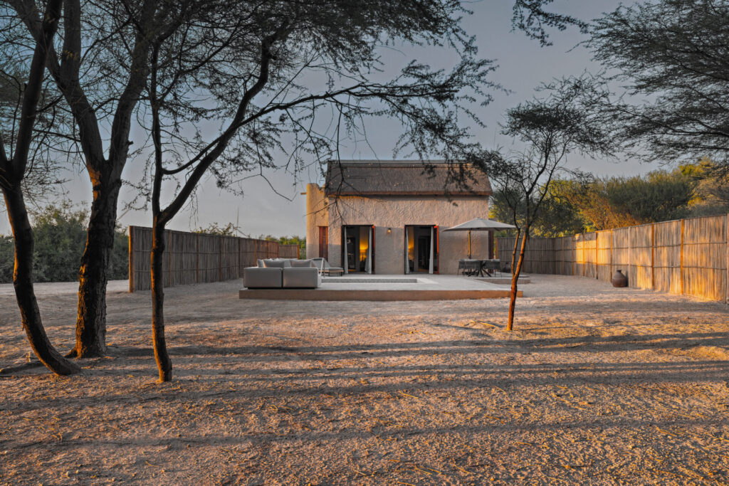Sir Bani Yas Island Al Sahel Villa with sidr trees surrounding it at sunset