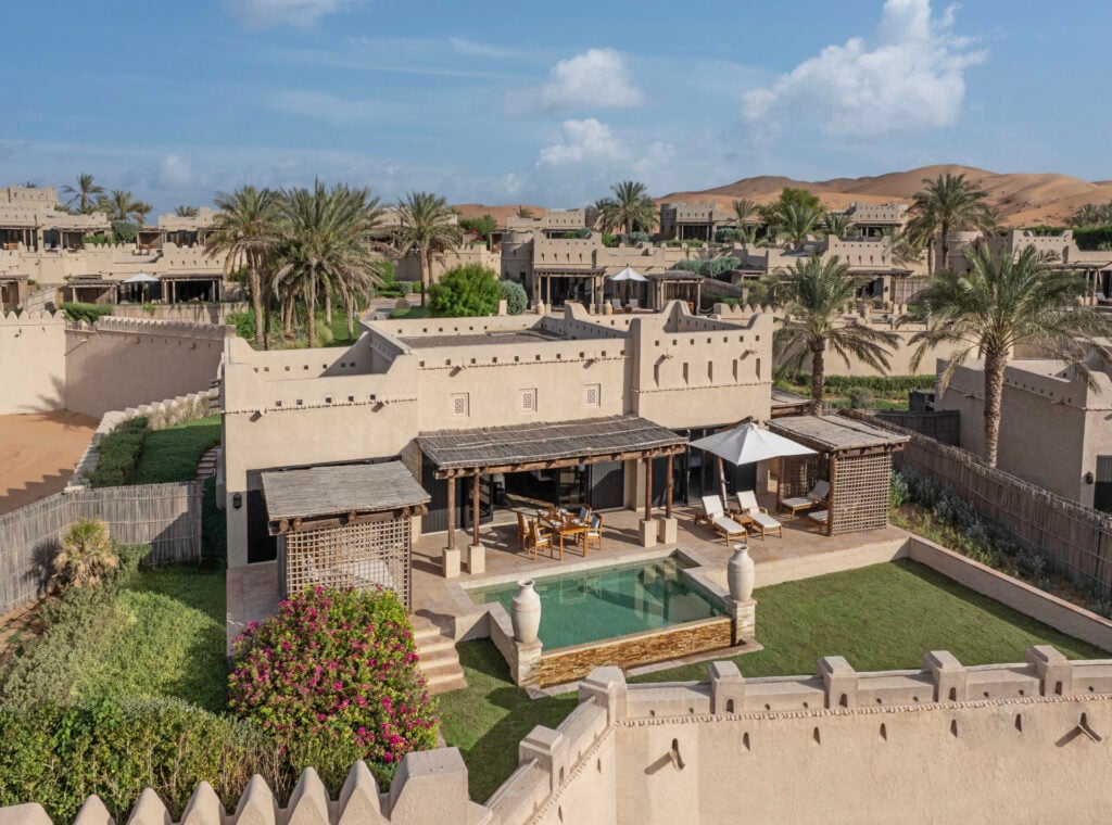 Qasr Al Sarab villa with pool and desert dunes in the background 