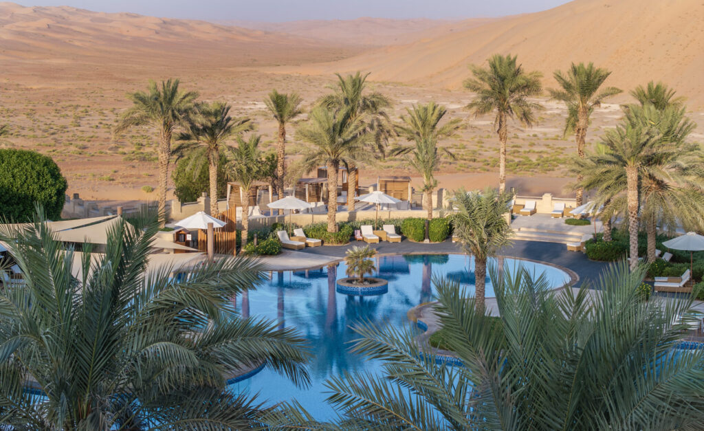 Poolside view of Qasr Al Sarab with surrounding desert