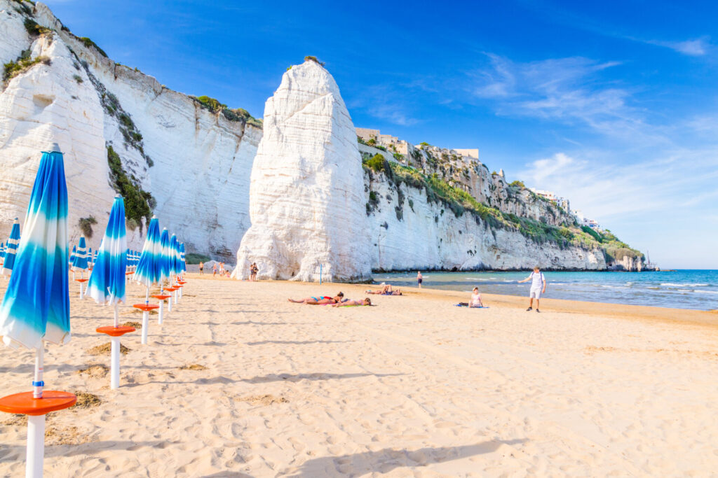 people taking pictures on a perfect beach presumably for Instagram
