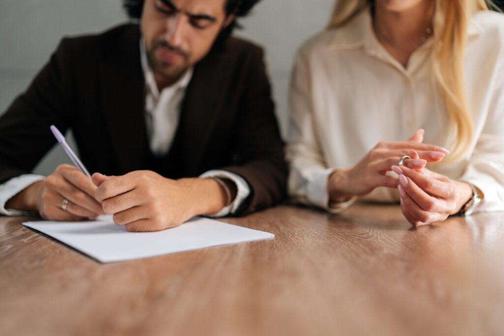 couple signing legal documents to reference divorce for entrepreneurs