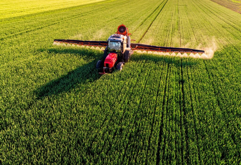 a tractor spraying a field