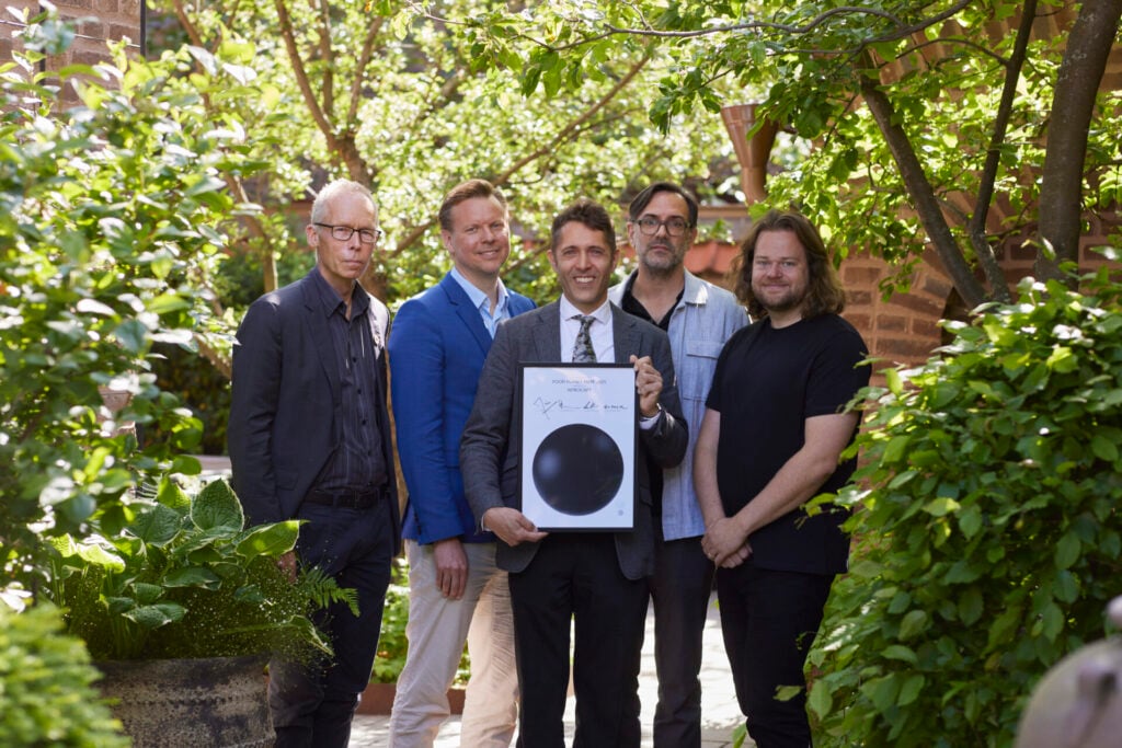 Food Planet Prize Winners and jury stand together in a garden 