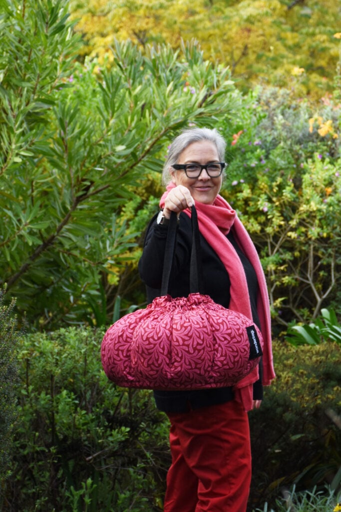 Sarah Collins the founder holding a Wonderbag