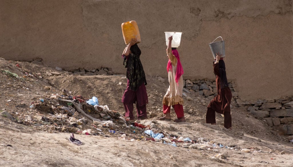girls carry water n their heads in Kabul, Afghanistan