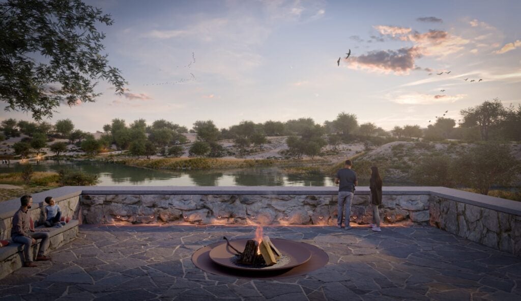 a couple standing next to a fire pit