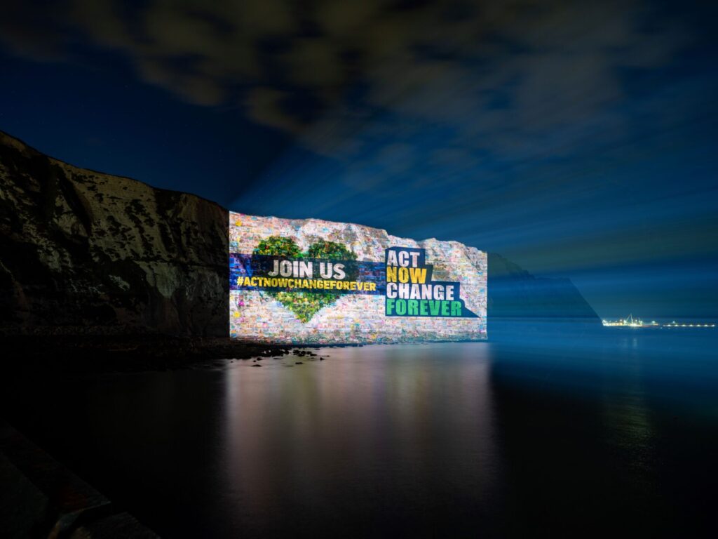 Lobby calling on the government to bring in climate change action projected on the white cliffs of dover