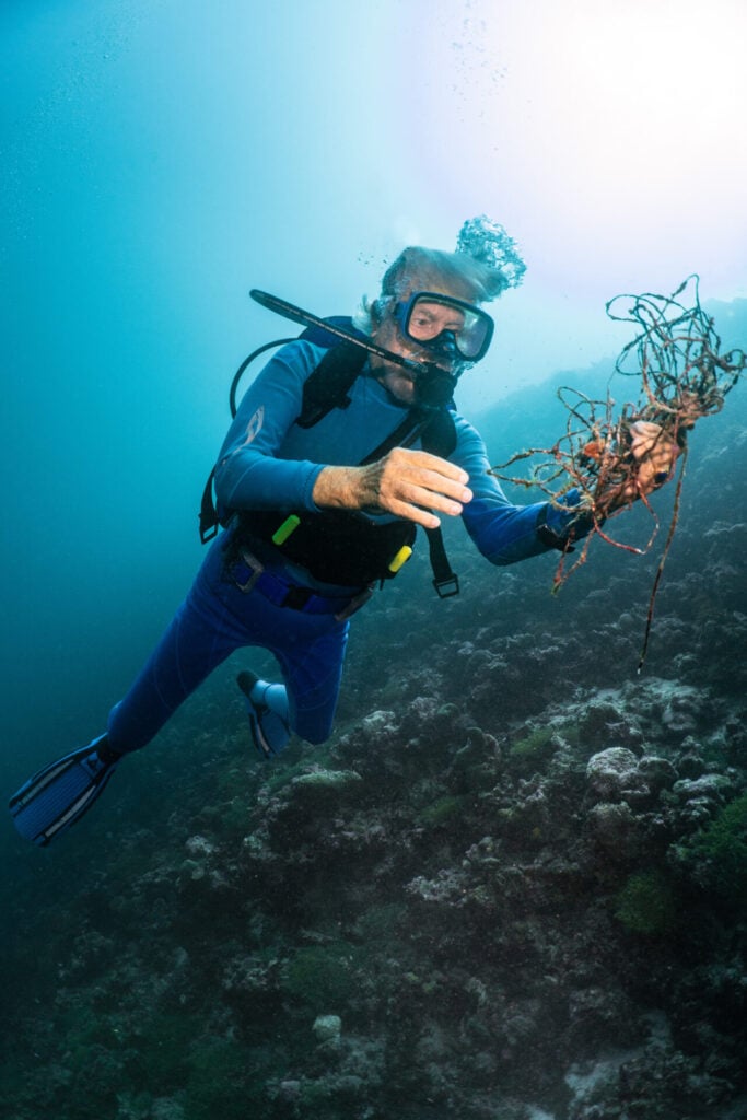 Jean-Michel Cousteau diving and collecting ocean litter