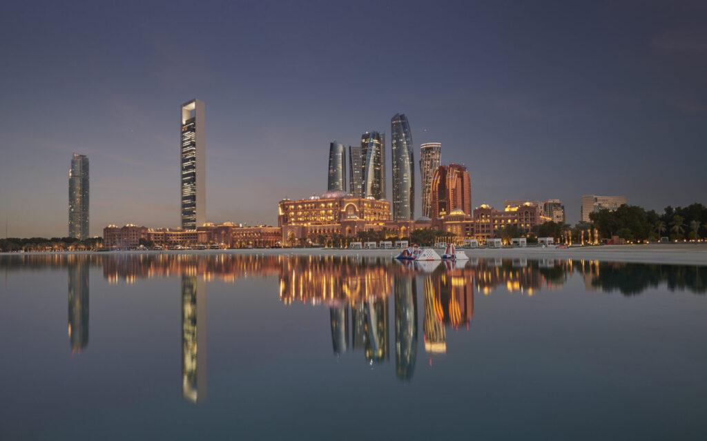 exterior of mandarin oriental emirates palace at night with reflection on the water