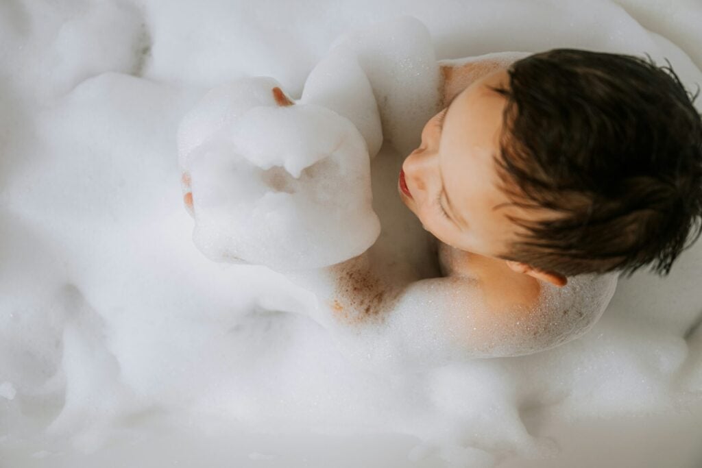 little baby in bath blowing bubble bath bath 