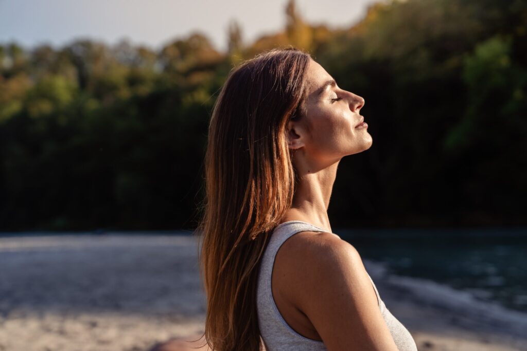woman outside facing the sun