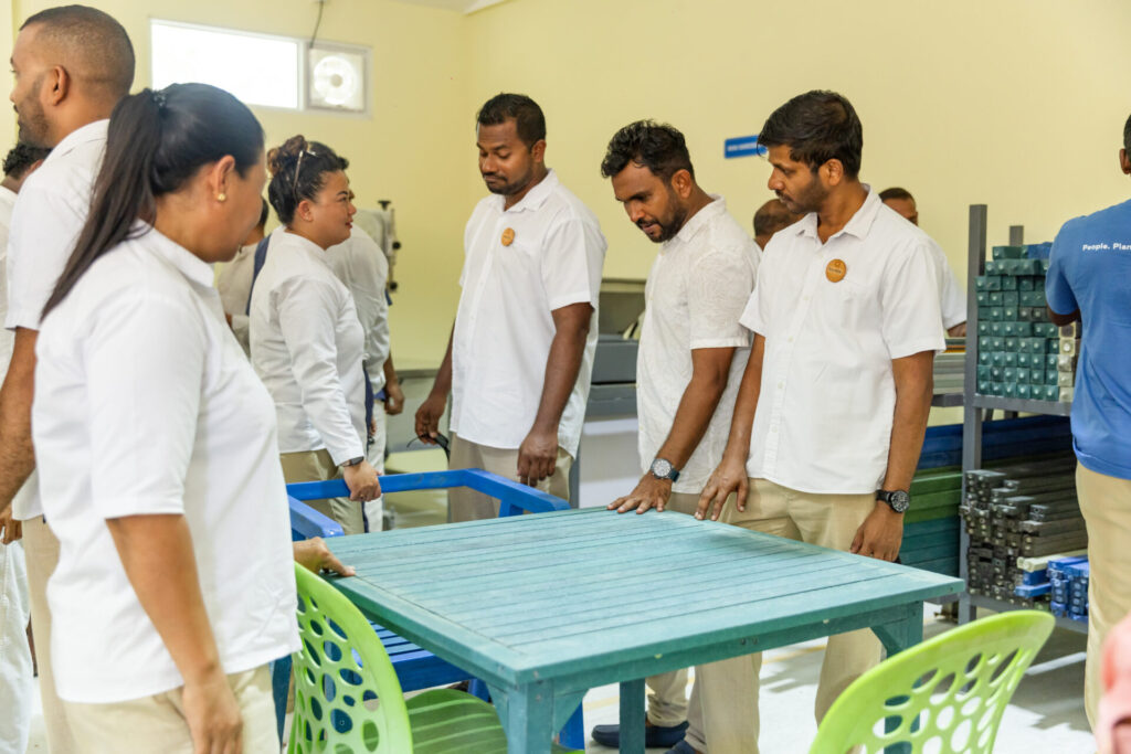 team members inspect a table made from plastic waste at Siyam World Maldives 