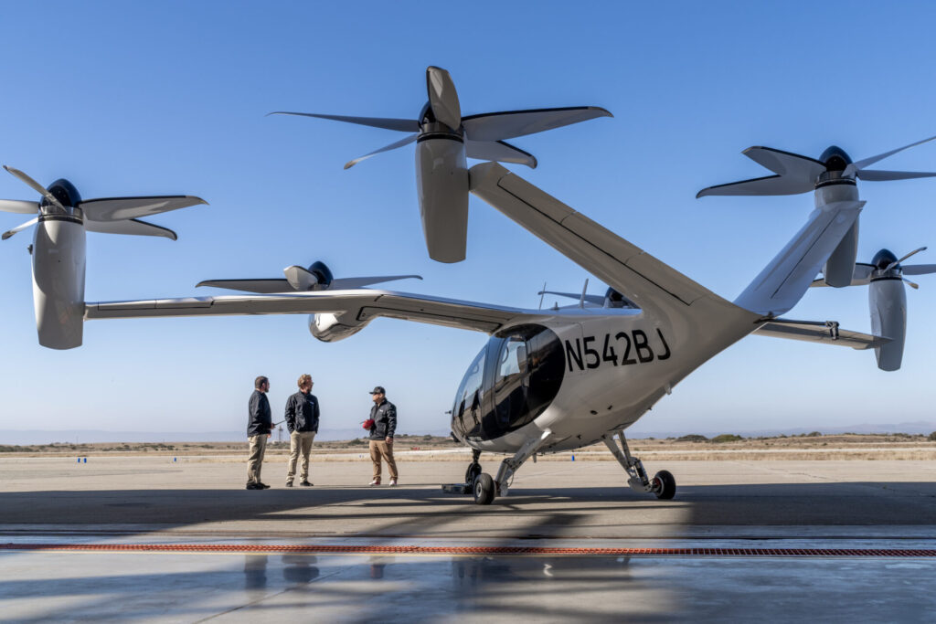 The eVTOL plane with men on the tarmac 