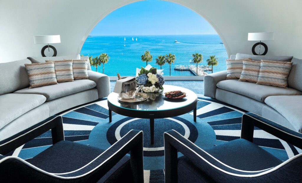 a room with a view of the ocean and a round table