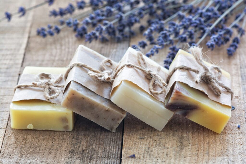 a group of bars of soap tied with string next to lavender