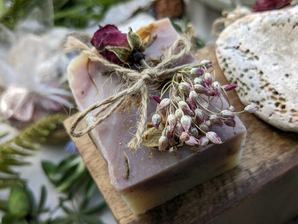 a bar of soap with dried flowers on top of it