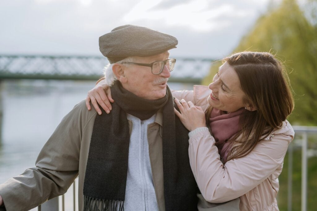 a woman hugging an elderly man