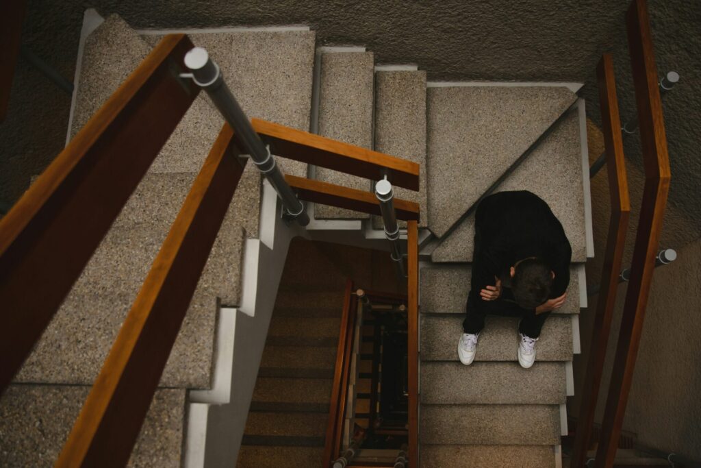 a boy sitting on a staircase at school