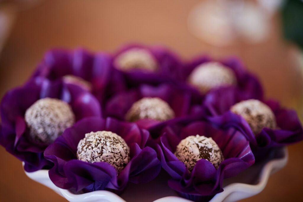 Chocolate truffles in purple flower cups