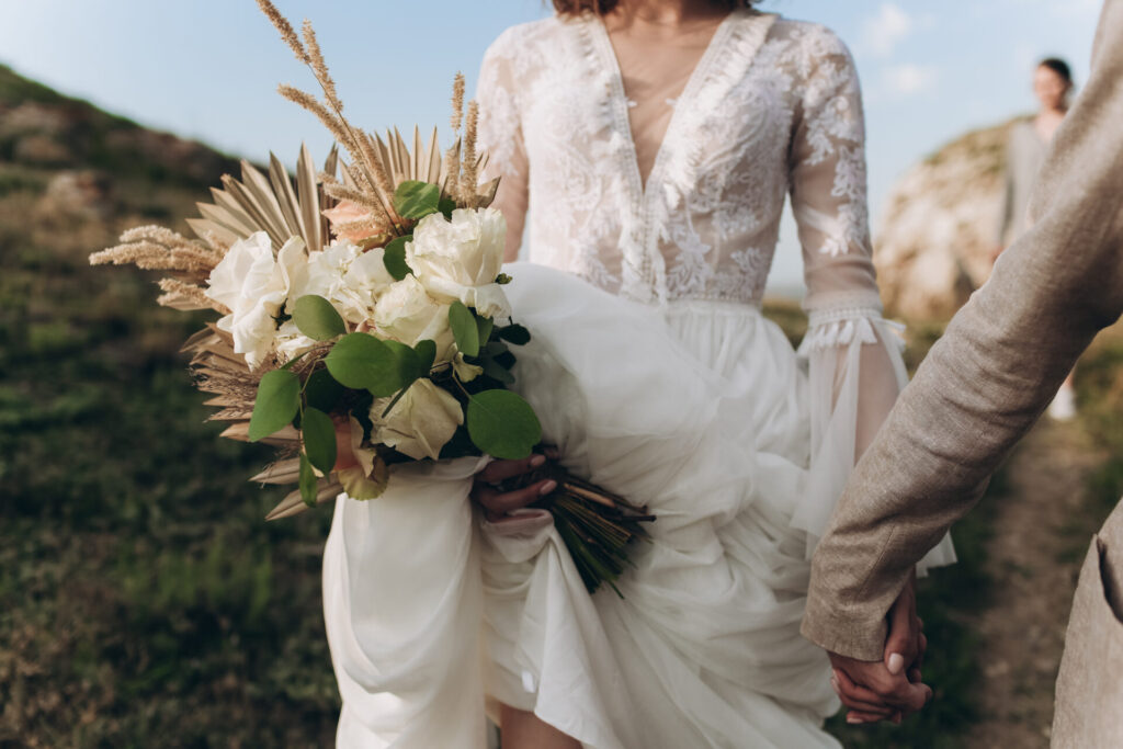 a woman in a white dress holding a bouquet of flowers