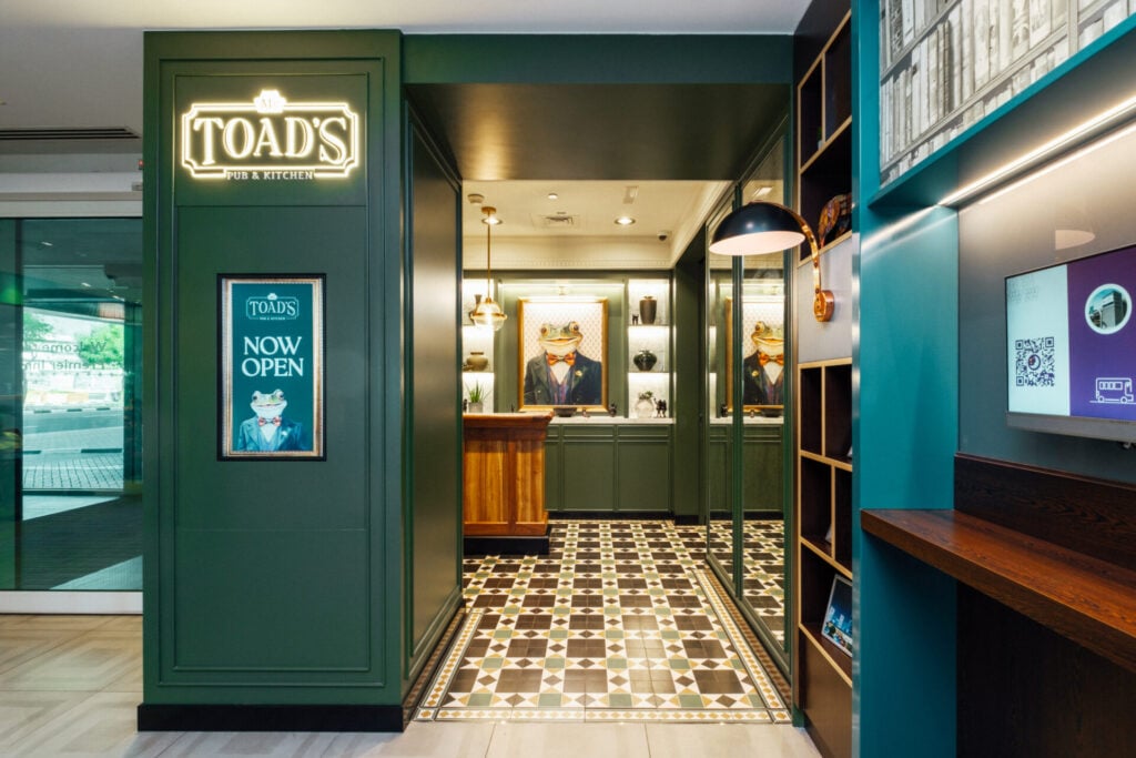 Elegant bar entrance with frog theme.