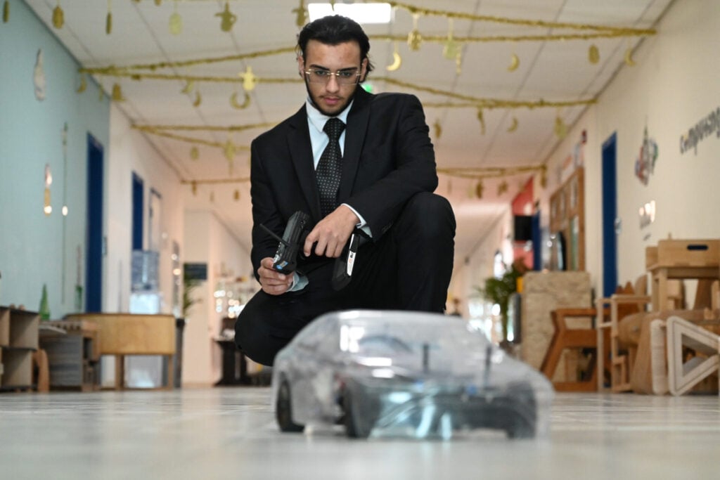 Man controlling remote car indoors for Project Hydronova