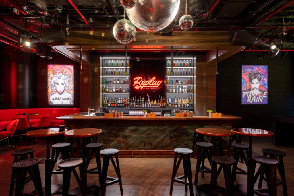 Vibrant karaoke bar with neon lights.