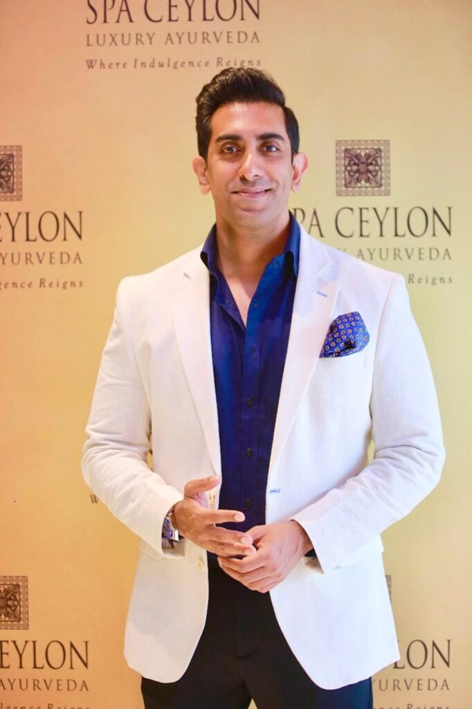 Shalin Ria the co-founder of Spa Ceylon wearing a white suit and blue shirt 