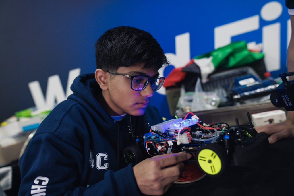 boy working on hydrogen car as part of Project Hydronova