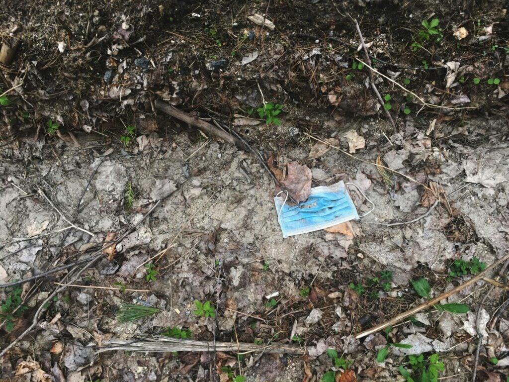 covid mask lying in the ground as litter