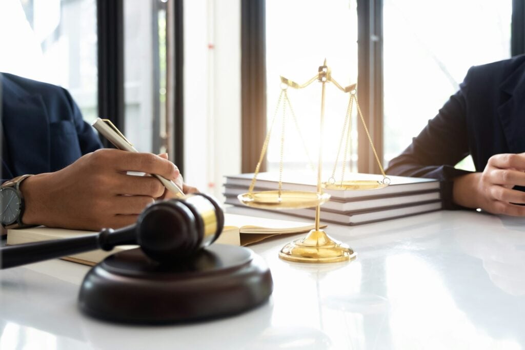 Legal discussion with gavel and scales