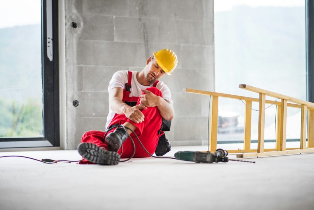 Construction worker resting on floor.