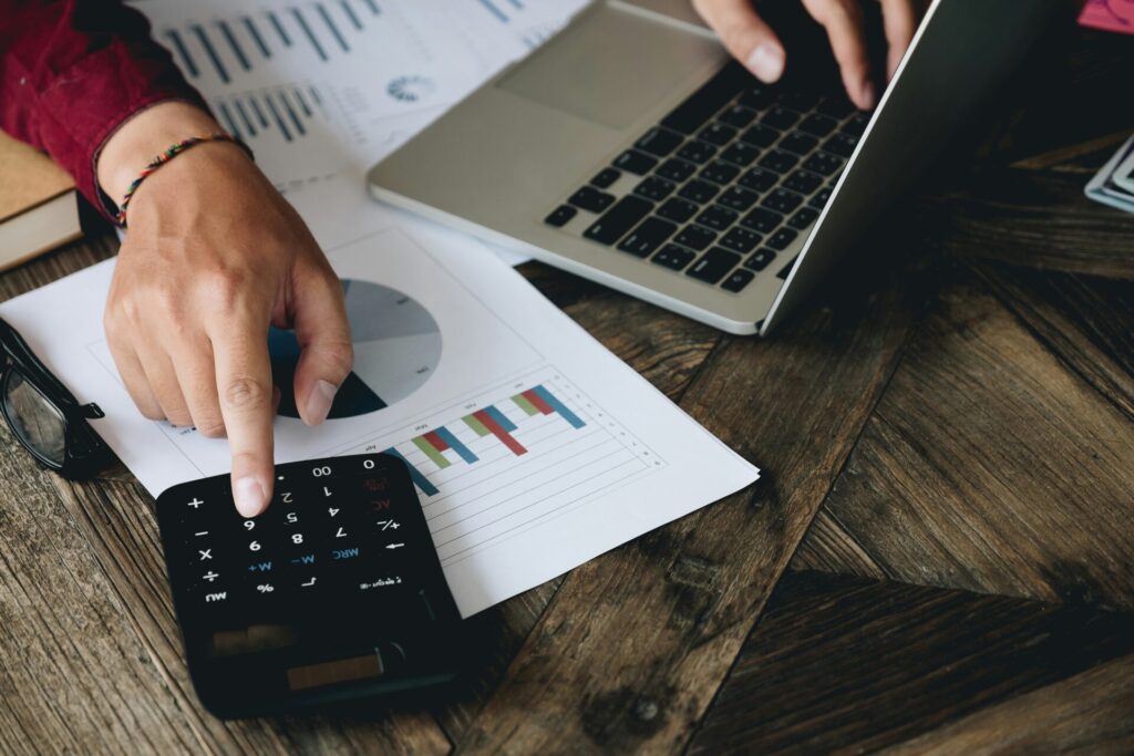 Person calculating data with laptop