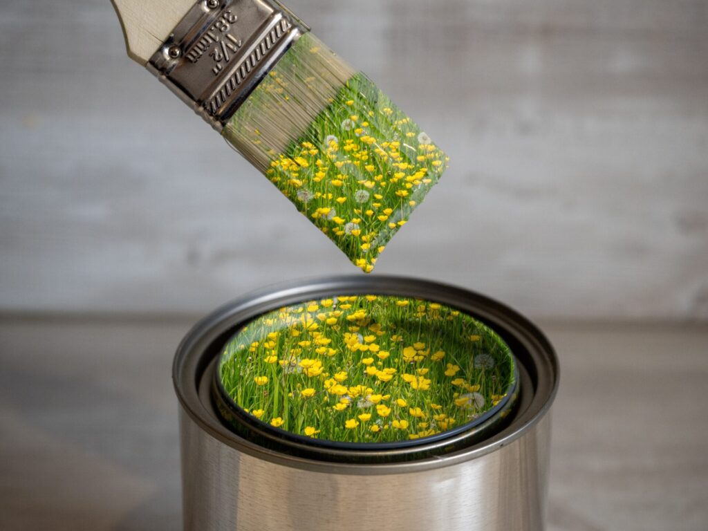 Paintbrush dipping into flower paint
