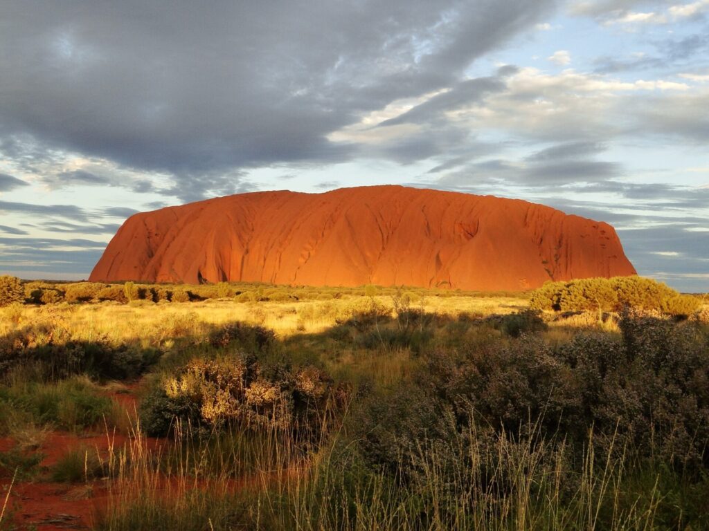 Uluru at sunset with clouds