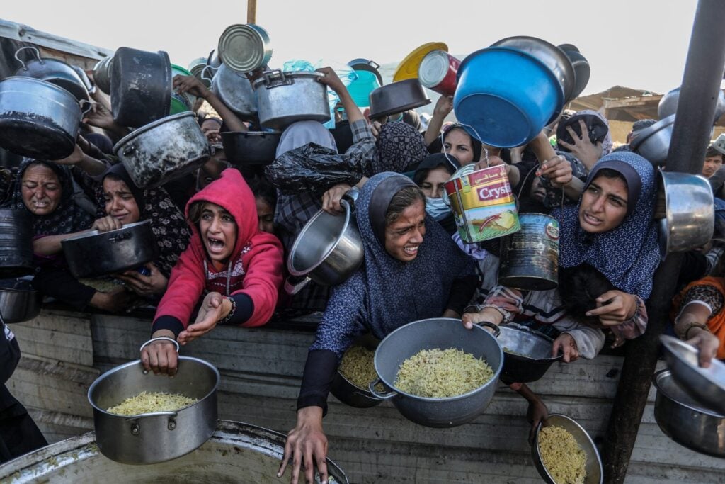 People collecting food in containers.