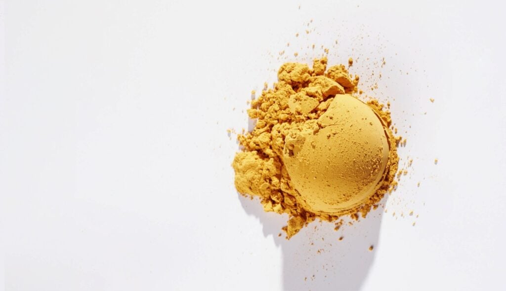 Yellow powder on white background
