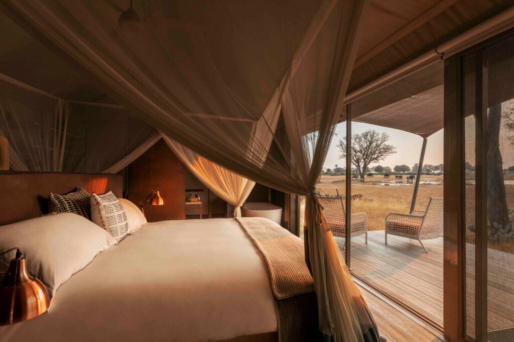 Luxurious tented bedroom with nature view.