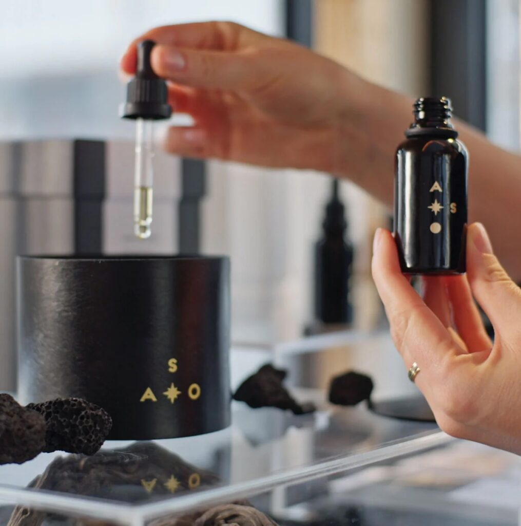 Person holding dropper and bottle