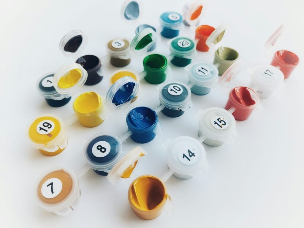 Colorful paint pots arranged neatly.
