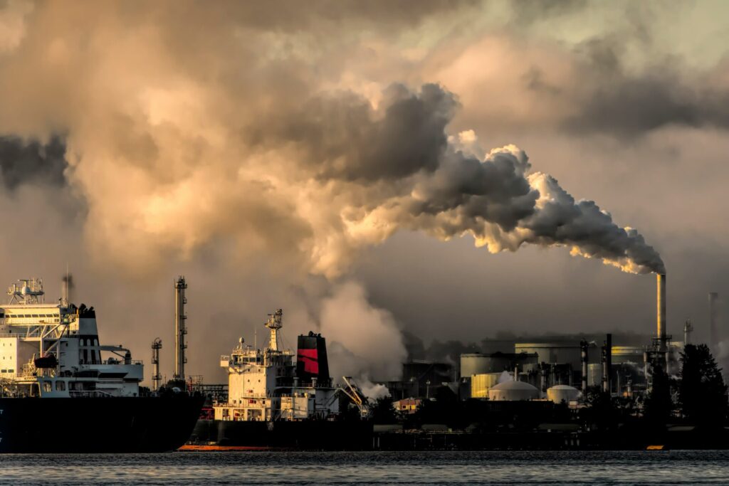 Industrial smoke rising over water