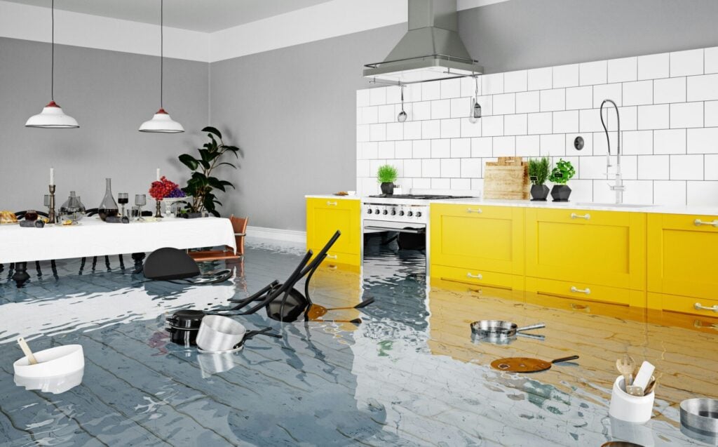 Flooded kitchen with floating utensils.